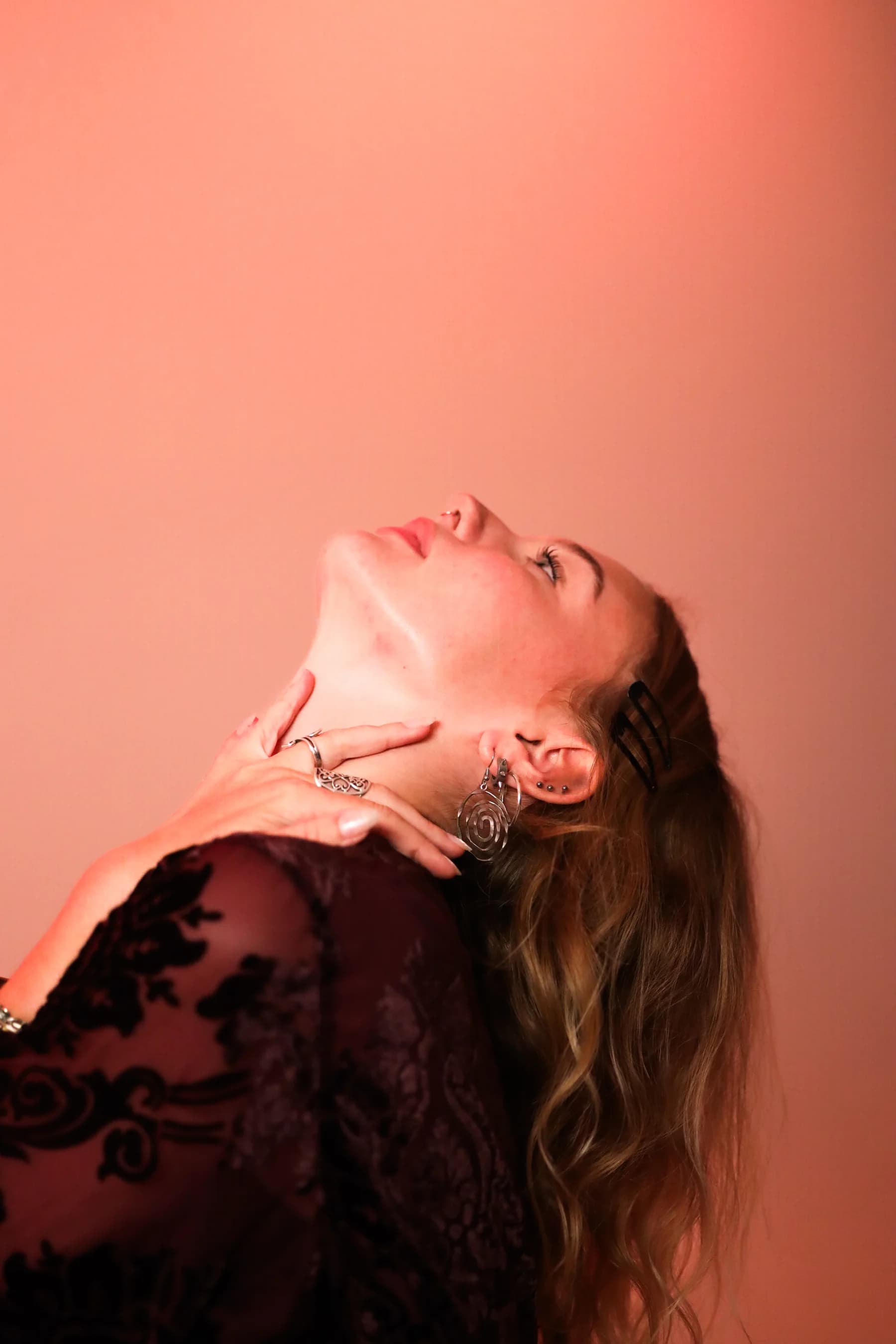 Expressive studio portrait of a dancer arching her head back into the light