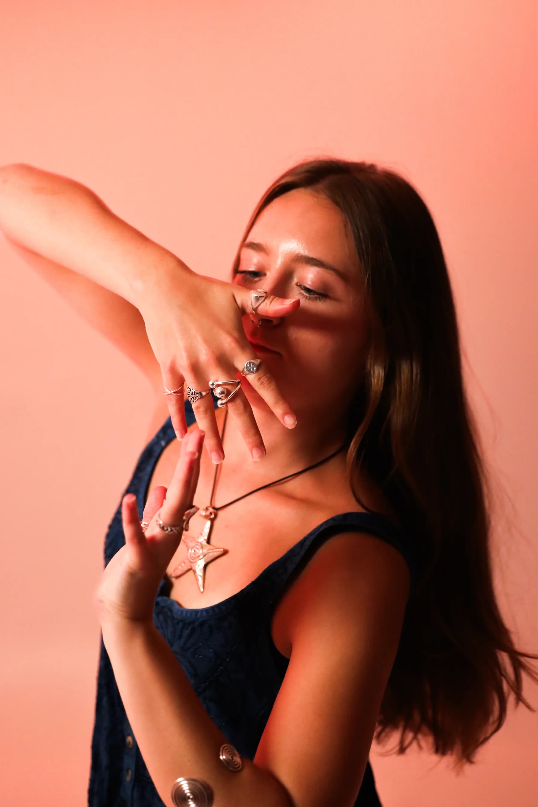 Expressive studio portrait of a dancer with a hand sweeping across her face